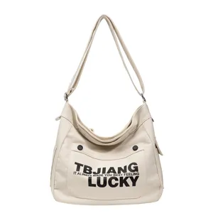 Casual canvas shoulder bag for women, large capacity crossbody tote bag with stylish letter print.