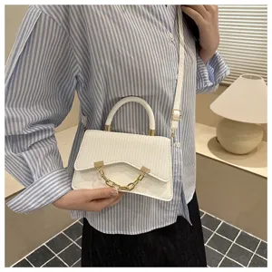 Women white crossbody shoulder bag, woven flap design with gold chain detail, stylish detail view.