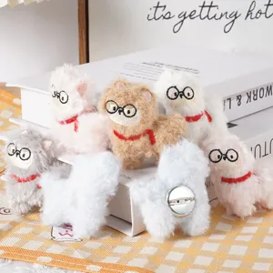 Cute plush alpaca brooch with glasses and scarf, soft stuffed cartoon animal accessory detail shot.