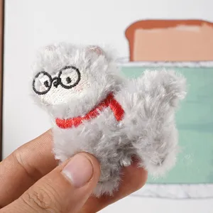 Close-up of the cute fluffy alpaca plush pendant featuring glasses and a red scarf detail.