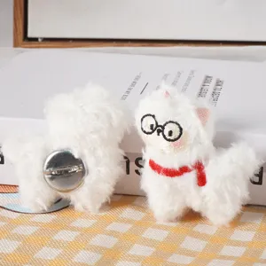 Close-up detail of cute fluffy alpaca plush brooch with glasses and red scarf pin accessory.