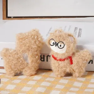 Close-up detail shot of cute fluffy alpaca plush toys with glasses and red scarf accents.