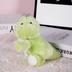 Green cute plush animal toy detail shot, soft stuffed doll resting on lace table decor.