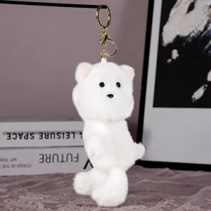 Close-up view of a fluffy white puppy plush keychain pendant, soft and cute accessory.