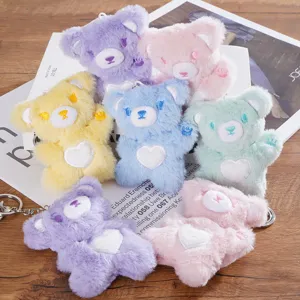 Cute plush bear keychain with heart patch, colorful stuffed animal doll bag pendant gift.