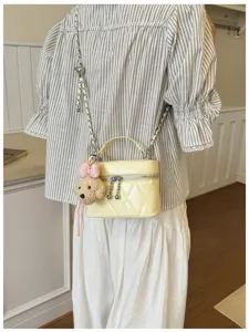 Women quilted chain crossbody bag stylish shoulder handbag with cute bear charm for autumn fashion.