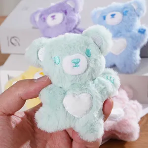 Cute plush bear keychain with heart patch, soft stuffed animal cartoon doll bag accessory.