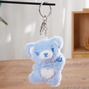 Blue plush bear keychain with a white heart embroidery, soft fluffy cartoon doll bag charm.