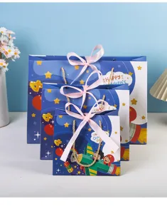 Children's day gift paper bag set with cute cartoon rocket print and pink ribbon bows for party.