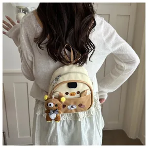 Detail view of the cute mini backpack with adorable bear plush pendant, premium PU leather.