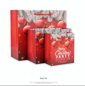 Set of festive Christmas gift paper bags featuring elegant red ornament and star designs for holiday.