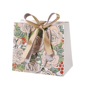 Champagne roos geschenkzak met strik, elegante papieren zak voor kleding en snoepjes.