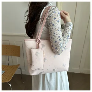 Pink tote shoulder bag with glitter butterfly print and small pouch detail for women.