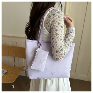Detailed view of the stylish purple tote bag with silver glitter butterflies for women.
