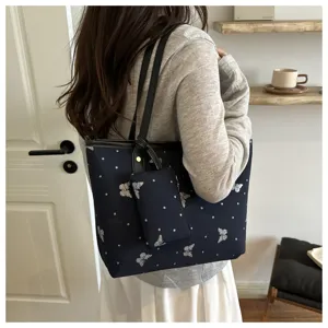 Stylish dark blue tote bag with glitter butterfly pattern, perfect for women's daily commute.