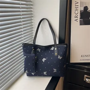 Dark blue tote bag with silver glitter butterflies and matching pouch for daily commute style.