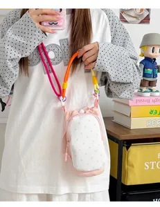 Close-up detail of the colorful drawstring polka dot crossbody phone and cup bag strap.
