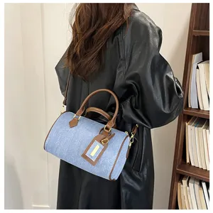 Women denim Boston shoulder bag vintage casual cross-body handbag with brown leather handle.