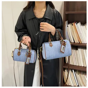 Vintage denim boston handbag for women, casual crossbody shoulder bag with brown leather trim.