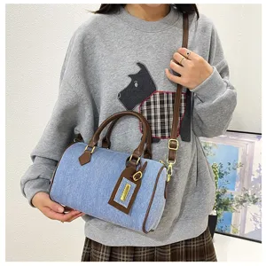 Vintage denim Boston handbag for women, casual crossbody and shoulder bag with brown trim.
