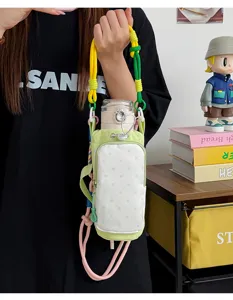 Crossbody water bottle bag with colorful strap, green polka dot canvas pouch for outdoor use.