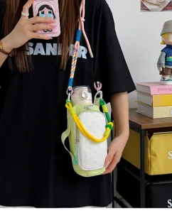 Colorful canvas crossbody water bottle bag with cute polka dot pocket and braided strap.