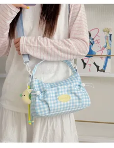 Blue and white plaid canvas shoulder bag with cute moon pendant and functional pockets.