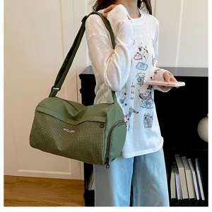 Small lightweight green travel duffel bag with grid pattern, casual sports gym shoulder bag.
