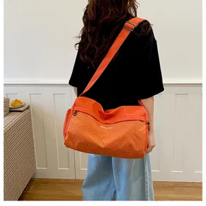 Lightweight orange grid travel shoulder bag, portable casual fashion tote for women's daily trips.
