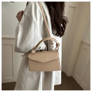 Minimalist leather shoulder bag for women, chic crossbody bag with top handle and flap design.