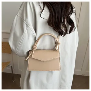 Minimalist beige crossbody shoulder bag with stylish knotted handle for women daily wear.
