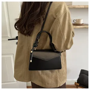 Stylish black leather crossbody shoulder bag for women, trendy chic design with top handle.