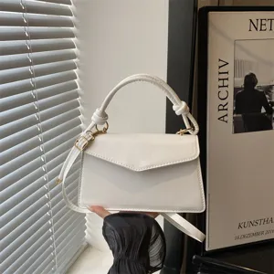 Minimalist white structured shoulder bag, stylish crossbody purse with top handle for women.