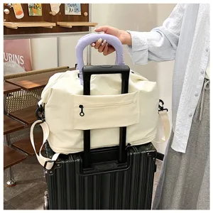 Large capacity travel duffel bag with handle wrap, waterproof canvas luggage for short trips.