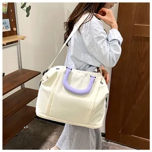 Large capacity travel duffel bag, stylish casual shoulder handbag with purple handle for daily trips.