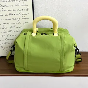 Large capacity travel duffel bag for women, waterproof short trip luggage bag with shoulder strap.