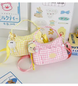 Women's plaid canvas shoulder bag, 2026 casual trendy crossbody bag with cute charm.