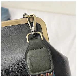 Detail opname van vintage dames schoudertas met retro metalen frame en stijlvol design.