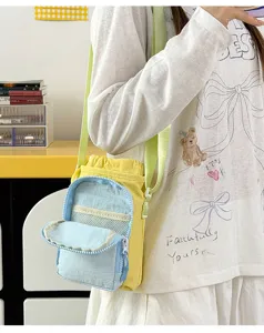 Close-up detail shot of yellow and blue canvas water bottle crossbody bag with adjustable strap.