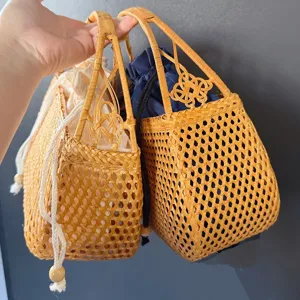 Detailed view of handmade woven rattan bag with drawstring lining and decorative knot handle.