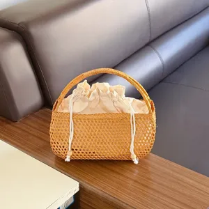 Woven rattan handbag with inner drawstring pocket, vintage style straw basket for women detail view.
