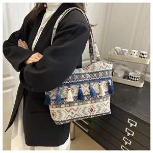 Vintage ethnic style woven tote bag with tassels, large capacity casual commuter shoulder bag.