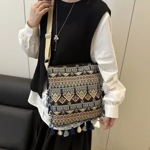 Ethnic style canvas crossbody bag with geometric patterns and tassels for women daily commute.