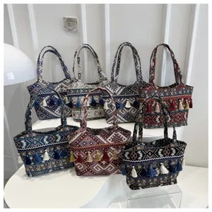 Retro ethnic style large capacity canvas tote bag with tassels for women daily commuting work.