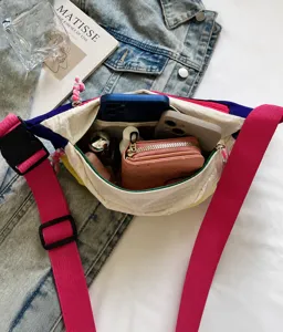 Detailed view of colorful crossbody sling bag showing spacious interior compartments and pockets.