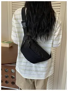 Black lightweight crossbody sling bag for daily travel, casual chest bag with adjustable strap.