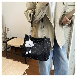 Detailed view of the stylish black star pattern tote shoulder bag with cute cloud keychain.