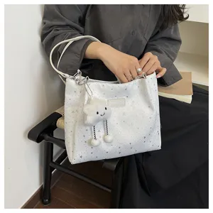 Casual white shoulder tote bag with star pattern and cute cloud plush charm for daily commute.