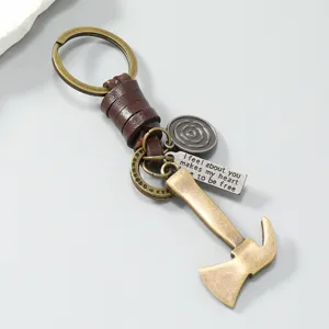 Vintage metal axe keychain with genuine leather strap, retro bronze mens pendant accessory.