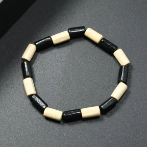 Pulsera de cuentas de madera retro simple con diseño cilíndrico negro y beige.